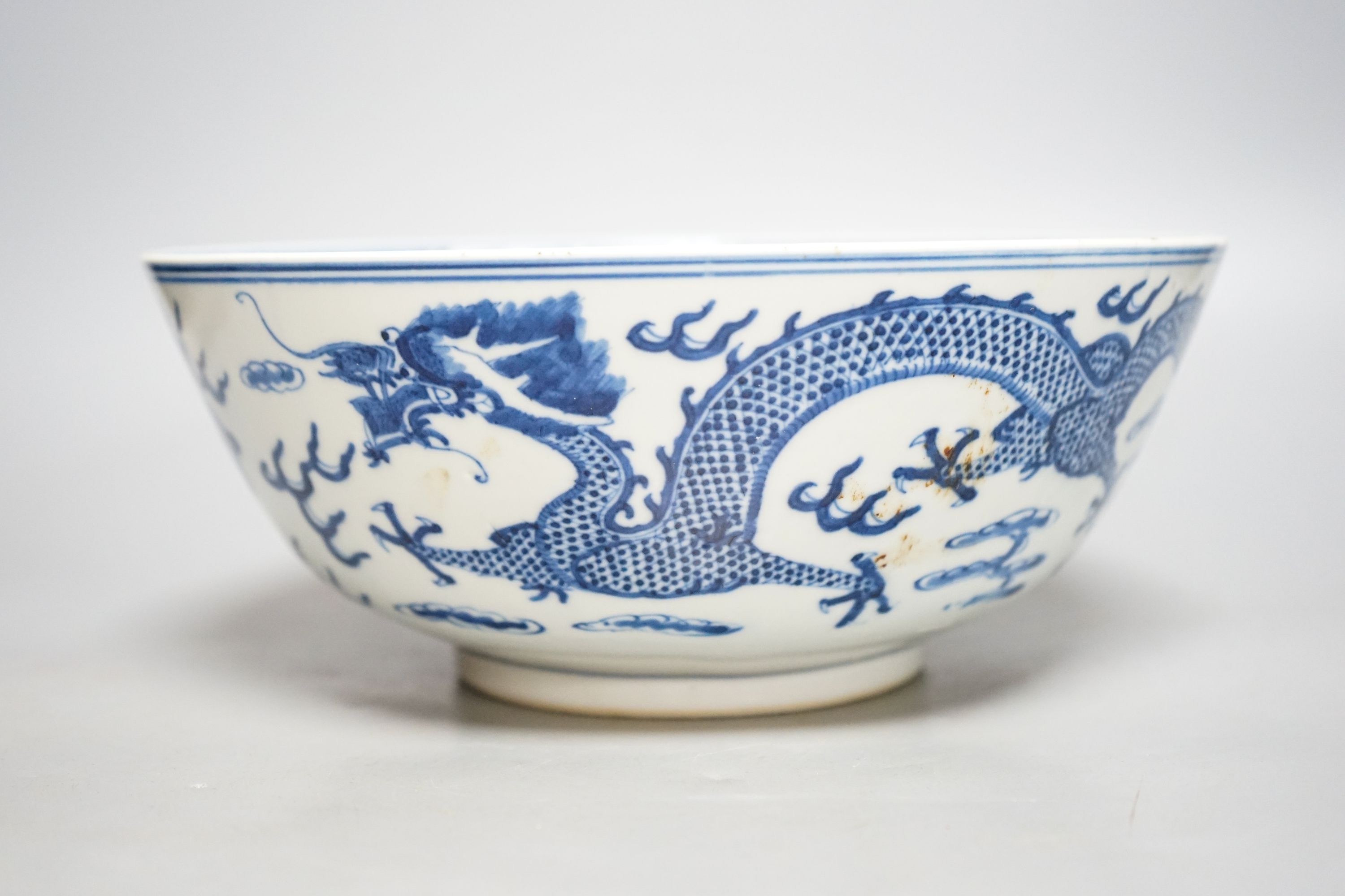 A Chinese blue and white ‘dragon’ bowl, Kangxi mark, late 19th century 25cm